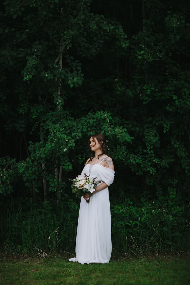 Tintype of newlyweds standing before a storybook cottage