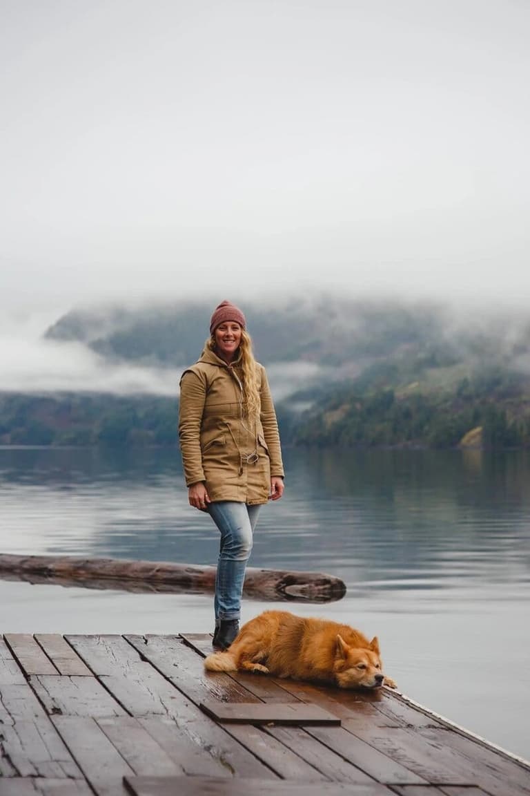Meredith Rose on a misty lakeside dock with her dog
