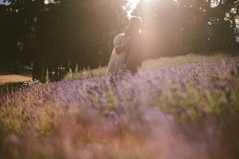 Couple embracing at sunset among lavender rows at Lavender & Black