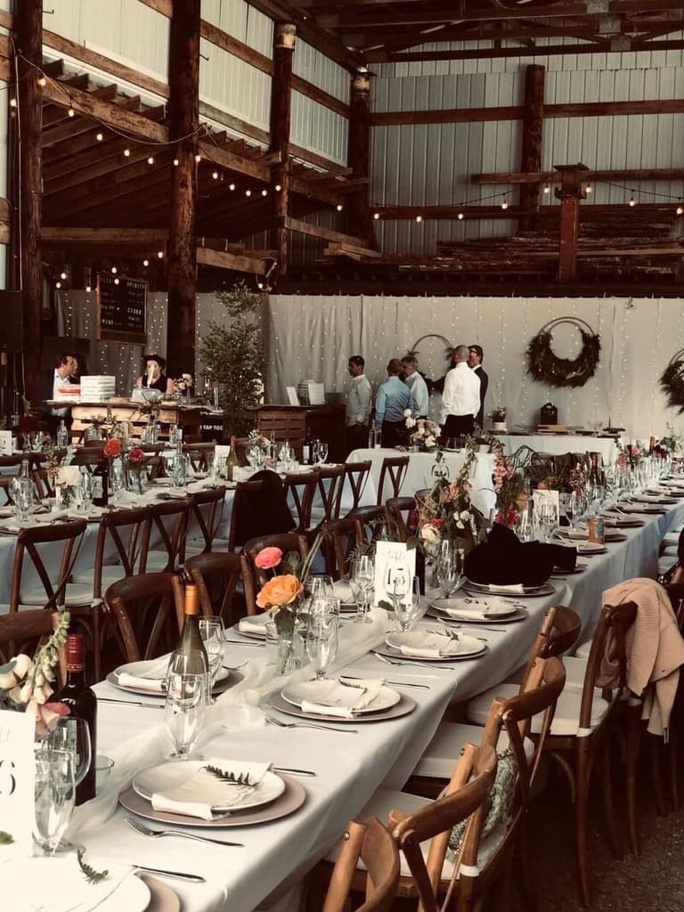 Long banquet tables with cross-back chairs from Triple T Party Rentals