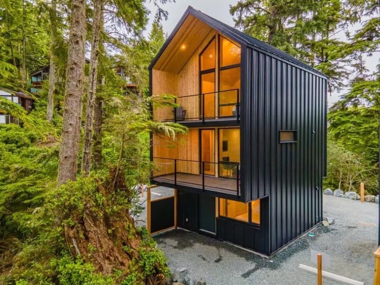 Black-clad modern cabin glowing at The Cabins at Terrace Beach