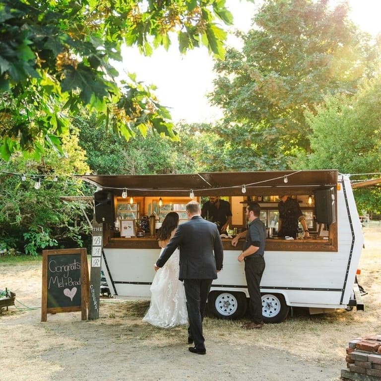 Newlyweds ordering drinks at the TravelBar mobile bartending trailer