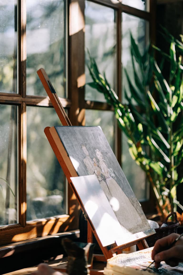 Wedding canvas in progress on a tabletop easel in golden light