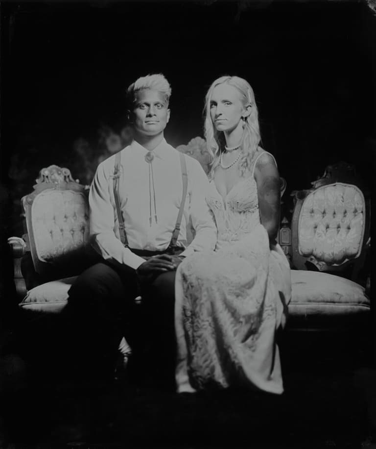 Couple in suspenders and lace posed for a formal plate