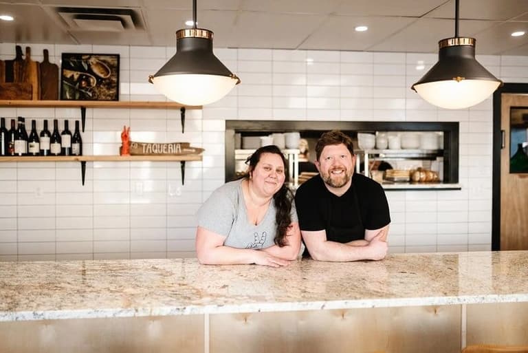 More Eatery chefs leaning on their restaurant's stone counter