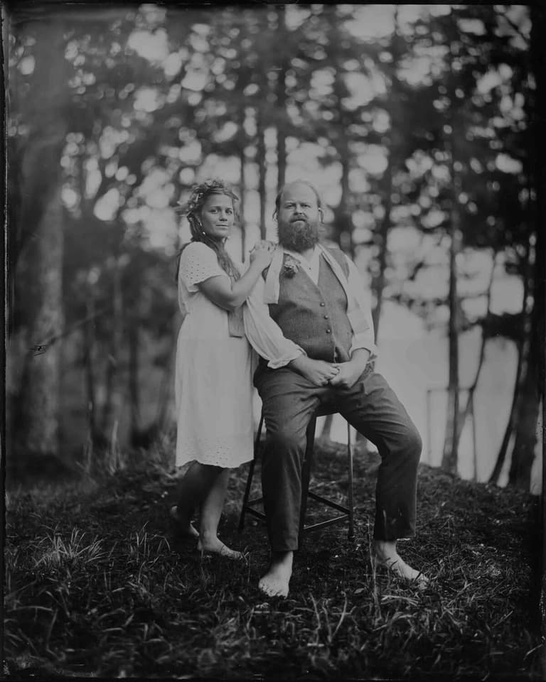 Tintype of a barefoot couple posed on a wooded hillside