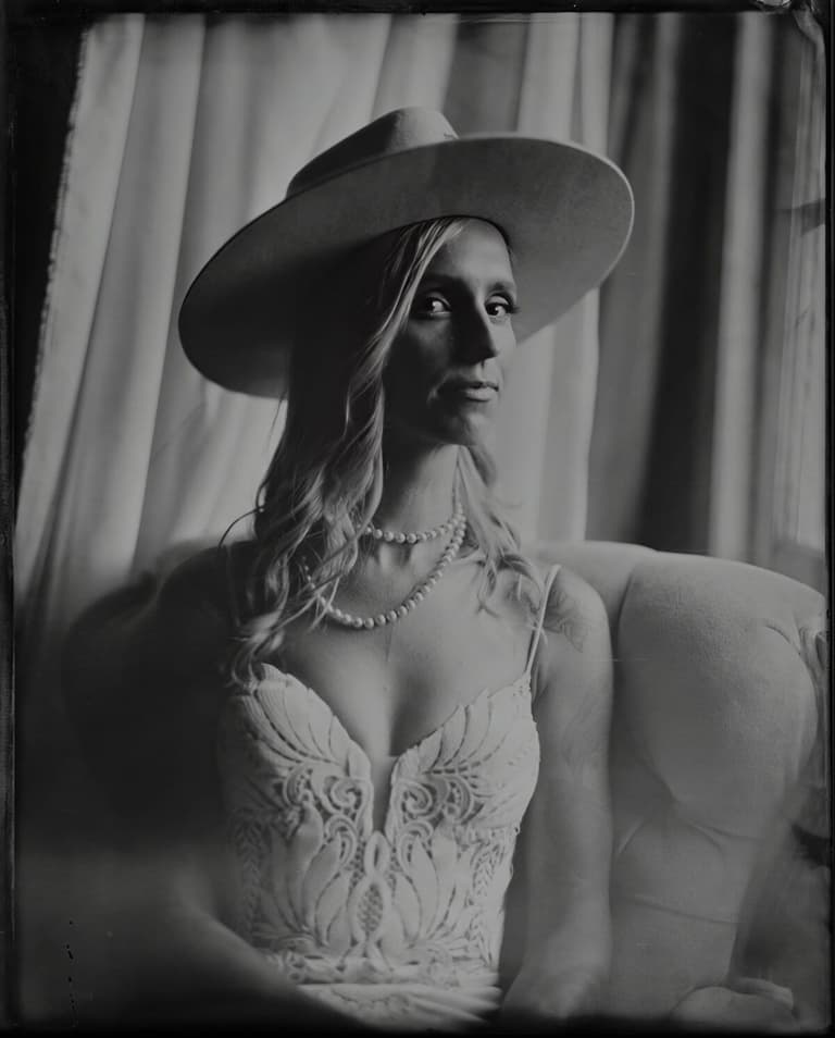 Bride in a wide-brimmed hat and pearls, tintype portrait