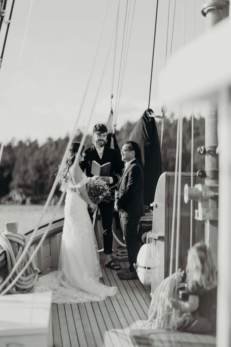 Shipboard wedding ceremony with a young guest watching from the deck