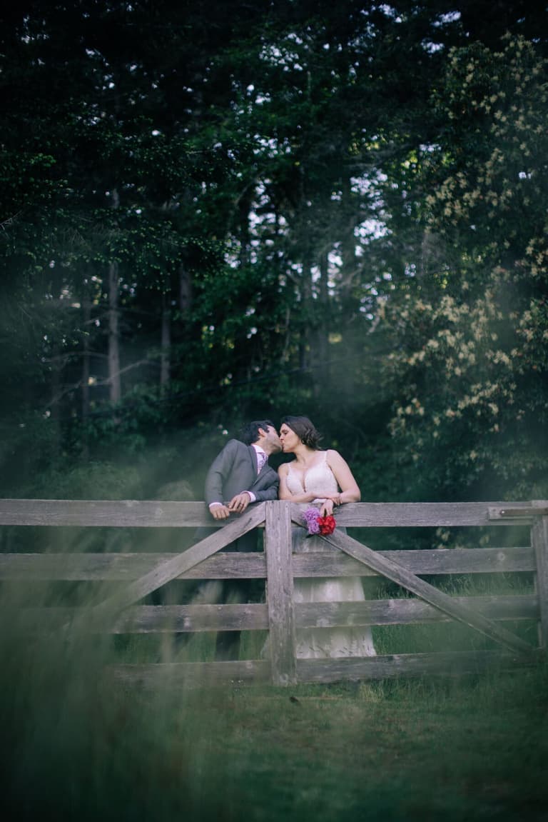 Kiss at the farm gate as evening settles over the forest