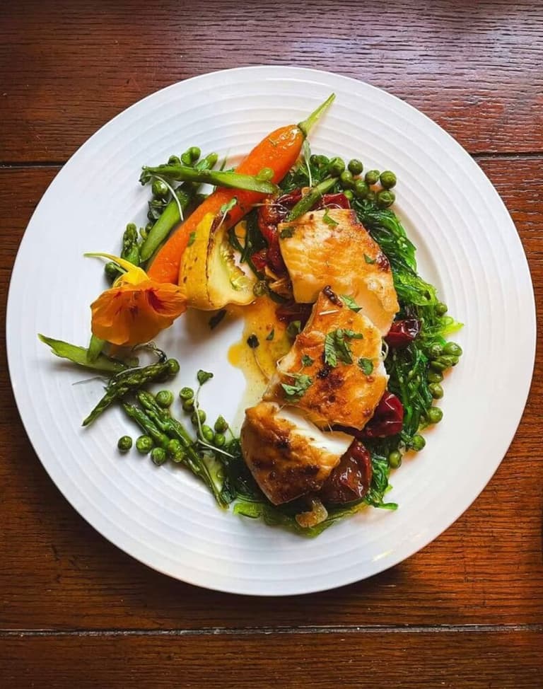 Roast chicken with spring vegetables plated by The Fridge Light Studio