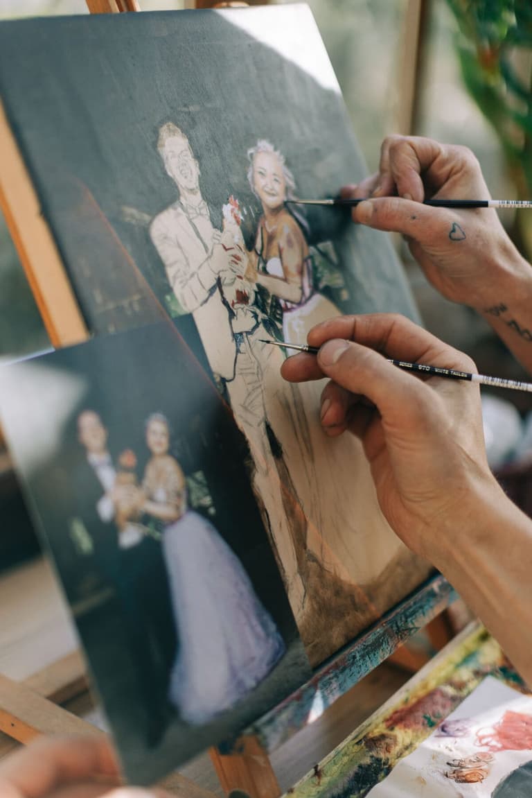 Hands detailing bride and groom from a reference photo on canvas
