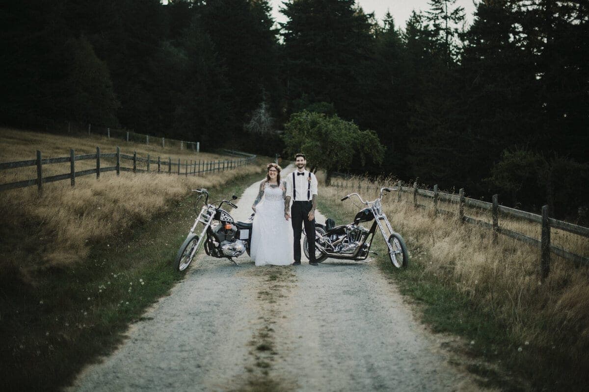 Bride and groom flanked by choppers on a country lane