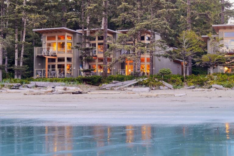 Pacific Sands beachfront suites glowing above the driftwood line